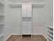 Walk-in closet featuring custom built-in shelving and ample storage space for clothes at 7108 Harvest Glen Ln, Riverview, FL 33578