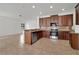 Modern kitchen with stainless steel appliances, granite countertops, tile backsplash, and tile flooring at 7108 Harvest Glen Ln, Riverview, FL 33578