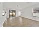 Spacious open living room with tile floors, neutral paint, and natural light from the sliding glass doors at 7108 Harvest Glen Ln, Riverview, FL 33578
