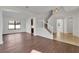 Spacious living room boasts wood floors, white walls, and staircase at 7108 Harvest Glen Ln, Riverview, FL 33578