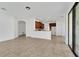 Open living space with tile floors, and white walls that connects to kitchen and offers backyard access at 7108 Harvest Glen Ln, Riverview, FL 33578