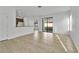 Open-concept living space with tile floors, white walls, bar seating, and sliding door access to backyard at 7108 Harvest Glen Ln, Riverview, FL 33578