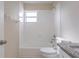 Bathroom features a granite vanity, shower/tub combo and white tile floor at 8528 Gold Ridge Cir, Tampa, FL 33619