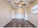 Bedroom with wood-look floors, ceiling fan, and two closets at 8528 Gold Ridge Cir, Tampa, FL 33619