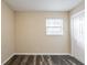 Bedroom featuring gray wood-look plank floors, window, and neutral paint at 8528 Gold Ridge Cir, Tampa, FL 33619