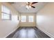 Bedroom featuring a ceiling fan, natural light, and wood-look flooring at 8528 Gold Ridge Cir, Tampa, FL 33619