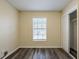 Cozy bedroom with neutral walls, gray vinyl flooring, closet, and a window providing natural light at 8528 Gold Ridge Cir, Tampa, FL 33619