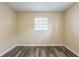 This bedroom has gray wood-look plank floors, neutral paint, and a window at 8528 Gold Ridge Cir, Tampa, FL 33619