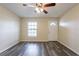 Living room features modern gray vinyl flooring, neutral paint, a front window, and a ceiling fan with lighting at 8528 Gold Ridge Cir, Tampa, FL 33619