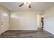 Open living room showing new gray vinyl flooring, neutral paint, and an opening to the kitchen area at 8528 Gold Ridge Cir, Tampa, FL 33619