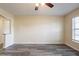 Open living room area features gray vinyl flooring, neutral paint, window, and access to the kitchen at 8528 Gold Ridge Cir, Tampa, FL 33619
