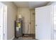 Utility room showcasing water heater and essential plumbing fixtures at 8528 Gold Ridge Cir, Tampa, FL 33619