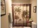 Bathroom featuring palm tree shower curtain and neutral decor at 4030 Worcester Rd, Sarasota, FL 34231