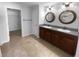 Bathroom with double sinks, granite countertop, and tile flooring at 36017 Stable Wilk Ave, Zephyrhills, FL 33541