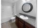 Bathroom features granite counters, vanity, shower and tub combo with tile surround at 36017 Stable Wilk Ave, Zephyrhills, FL 33541