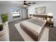 Spacious bedroom features a ceiling fan, large window, and stylish furnishings at 36017 Stable Wilk Ave, Zephyrhills, FL 33541