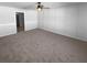 Spacious bedroom with plush carpet, ceiling fan, and neutral wall color at 36017 Stable Wilk Ave, Zephyrhills, FL 33541