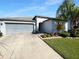This single-story home features a well-manicured lawn and a two-car garage at 36017 Stable Wilk Ave, Zephyrhills, FL 33541