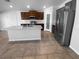 Modern kitchen featuring granite countertops, stainless steel appliances, and dark wood cabinets at 36017 Stable Wilk Ave, Zephyrhills, FL 33541