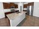 Modern kitchen features stainless steel appliances, granite countertops, and center island at 36017 Stable Wilk Ave, Zephyrhills, FL 33541