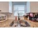 Close up shot of a kitchen sink with granite countertops and window with blinds above at 6800 20Th N St, St Petersburg, FL 33702