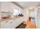 Well-lit kitchen with white subway tile backsplash, stainless steel sink, and ample cabinet space at 6800 20Th N St, St Petersburg, FL 33702