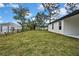 A well-maintained backyard featuring a lush green lawn and a modern home exterior at 10383 Lear St, Spring Hill, FL 34608