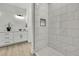 Contemporary bathroom with walk-in shower featuring marble tile design, with vanity and lighting at 10383 Lear St, Spring Hill, FL 34608