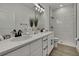 Modern bathroom with double sinks, white countertops, black fixtures, and walk-in shower at 10383 Lear St, Spring Hill, FL 34608