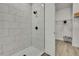 Spa-like bathroom with tiled walk-in shower and black hardware adjacent to an open walk-in closet at 10383 Lear St, Spring Hill, FL 34608