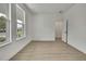 Bedroom featuring neutral walls, wood-look floors, recessed lighting, and a large window at 10383 Lear St, Spring Hill, FL 34608