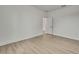 Bright bedroom features neutral walls, light wood floors, and view to doorway at 10383 Lear St, Spring Hill, FL 34608
