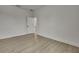 Bright bedroom features neutral walls, light wood floors, and view to doorway at 10383 Lear St, Spring Hill, FL 34608
