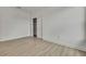 Bright bedroom features neutral walls, light wood floors, and closet with white door at 10383 Lear St, Spring Hill, FL 34608