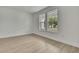 Bedroom featuring neutral walls, wood-look floors, and large windows that provide ample natural light at 10383 Lear St, Spring Hill, FL 34608