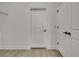 Bedroom with laminate floors, white trim, and paneled doors with black handles, great storage space at 10383 Lear St, Spring Hill, FL 34608