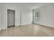Bright bedroom features neutral walls, light wood floors, window, and closet with white door at 10383 Lear St, Spring Hill, FL 34608