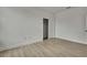 Bright bedroom features neutral walls, light wood floors, and closet with white door at 10383 Lear St, Spring Hill, FL 34608