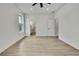 Bright bedroom featuring a ceiling fan, light hardwood floors, and white walls, creating a modern, airy space at 10383 Lear St, Spring Hill, FL 34608