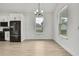 Open dining area connects kitchen with stainless steel appliances and natural light at 10383 Lear St, Spring Hill, FL 34608