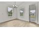 Bright dining area with natural light, a modern chandelier, and access to the patio at 10383 Lear St, Spring Hill, FL 34608