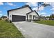 Charming single-Gathering home with white board and batten siding, gray garage door, and a well-manicured lawn at 10383 Lear St, Spring Hill, FL 34608