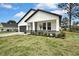 Charming home with white siding, gray accents, and a well-manicured lawn, close-up view of front at 10383 Lear St, Spring Hill, FL 34608