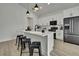 Modern kitchen with island seating, white cabinets, and stainless steel appliances at 10383 Lear St, Spring Hill, FL 34608