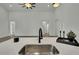 Modern kitchen with black faucet, white countertop, and stainless-steel sink featuring neutral walls and floors at 10383 Lear St, Spring Hill, FL 34608
