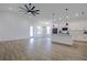 Bright, open-concept living space with wood-look floors flowing to the kitchen at 10383 Lear St, Spring Hill, FL 34608