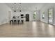 Spacious living area featuring modern kitchen, counter seating, and abundant natural light at 10383 Lear St, Spring Hill, FL 34608