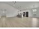 Bright open-concept living space with vaulted ceilings and modern kitchen at 10383 Lear St, Spring Hill, FL 34608