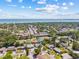 Aerial view of neighborhood, showcasing lush greenery and nearby ocean and Sunshine Skyway at 1154 64Th S Ave, St Petersburg, FL 33705