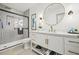 Stylish bathroom featuring a sleek glass shower, modern vanity with gold accents, and wood-look tile flooring at 1154 64Th S Ave, St Petersburg, FL 33705